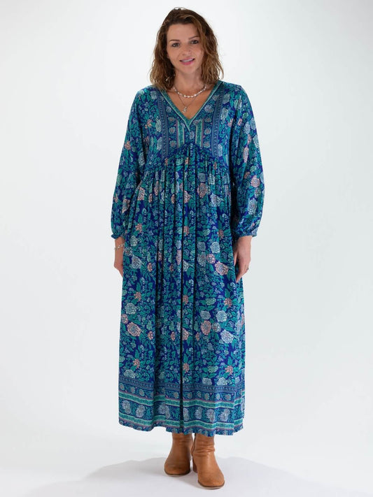 Woman wearing a blue floral boho maxi dress on a white background